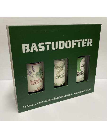 En grön ask med tre stycken flaskor med olika bastudofter